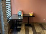 a small table with a vase on it in the corner of a room