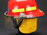 fireman ' s helmet with protective face shield and visor on a black background