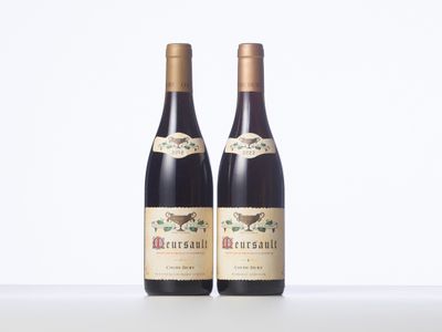 two bottles of wine sitting on top of a white table