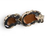 two pairs of black and white slippers on a white surface