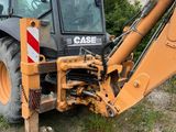 a backhoe of a construction vehicle parked in a field