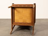 the chair is made of wood and has a woven seat