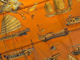 an orange scarf with a picture of ships and ships on it