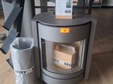 a small stove sitting in the middle of a room