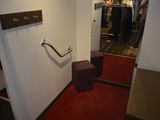 a red carpeted hallway leading to a closet with a mirror