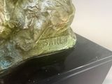 a statue of a dog that is sitting on top of a table