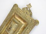 a picture of a gold picture frame on a white wall
