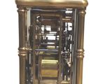 a clock that is sitting on a stand with a clock on top of it