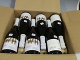 six bouteilles de vin dans un carton sur une table