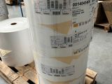 several rolls of paper are stacked on a pallet in a warehouse