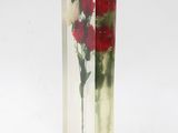 a clear vase with red and white flowers inside of it