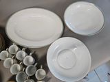 a lot of plates and bowls on the table
