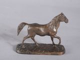 a bronze statue of a horse running on a marble base