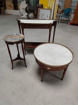 two tables and two stools in a room with a lot of furniture