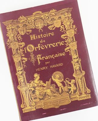 the front cover of a red book with gold writing on it