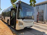 a white bus that is parked on the side of the road