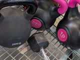 two kettle weights sitting on a wire rack in a store