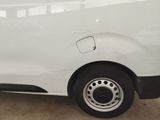a white van parked in a garage with a flat tire