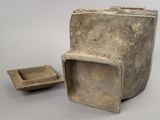 a small stone box and a small bowl on a table