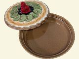 a picture of a pie with kiwi and cherries on it