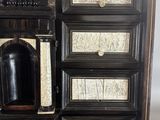an image of a black and white cabinet with drawers and a door
