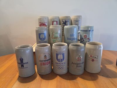 a lot of beer mugs sitting on a table