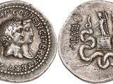 a silver coin with an image of a woman and a dragon on it