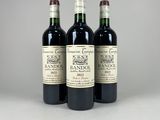three bottles of wine sitting on top of a table next to each other