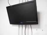 a flat screen tv hanging on the wall in the room