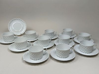 a lot of cups and saucers sitting on a table
