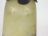 a glass vase with a black flower on top of it