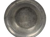 a metal bowl that is sitting on a white surface