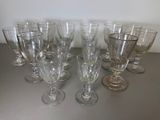 several empty wine glasses are lined up on a table