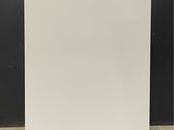 a white cabinet sitting on top of a floor next to a black wall
