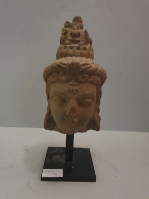 Tête de Tara en grés rose, avec, dans sa coiffe, le bouddha …