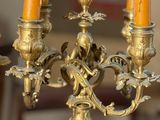 a gold candelab with five candles on it