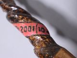 a close up of a wooden stick with writing on it