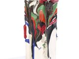 a vase with a painting on it sitting on a white surface