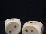 two wooden dices sitting on top of a table next to each other