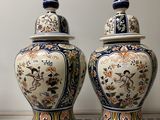 two vases that are sitting on a table