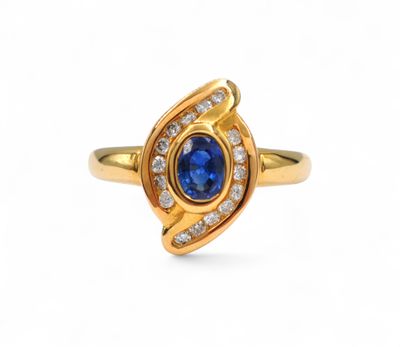 a gold ring with a blue sapphire and diamonds