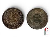 a close up of two coins on a white surface