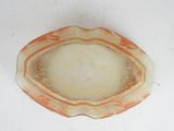 a small orange and white bowl on a white surface