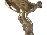 brass plate sculpture of a woman holding a spoon on a black base