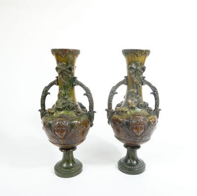 two vases that are sitting side by side on a white surface