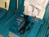 a blue tool box with a drill and a cord in it