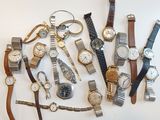 a lot of watches that are sitting on a table