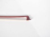 a red and white toothbrush sitting on a white surface