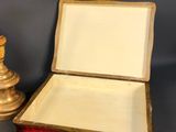 pair of antique brass candlesticks and a box with a red velvet lining