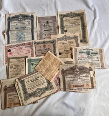 many old and worn paper money are on a white sheet